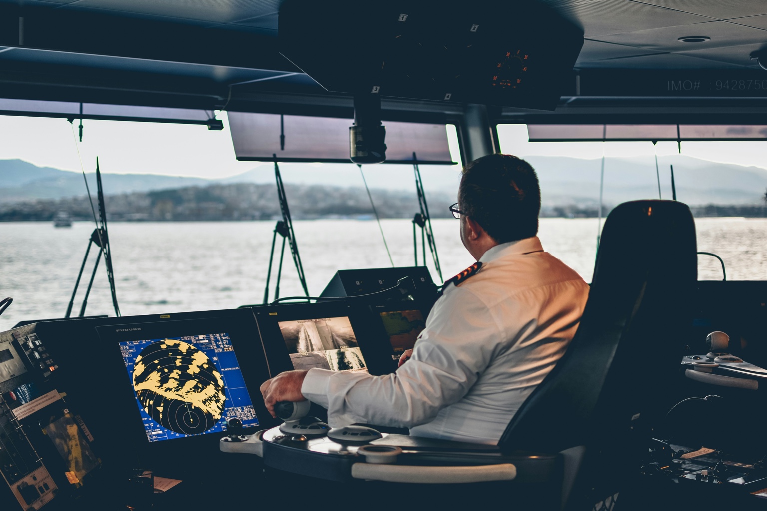 Captain on a modern ship bridge underway